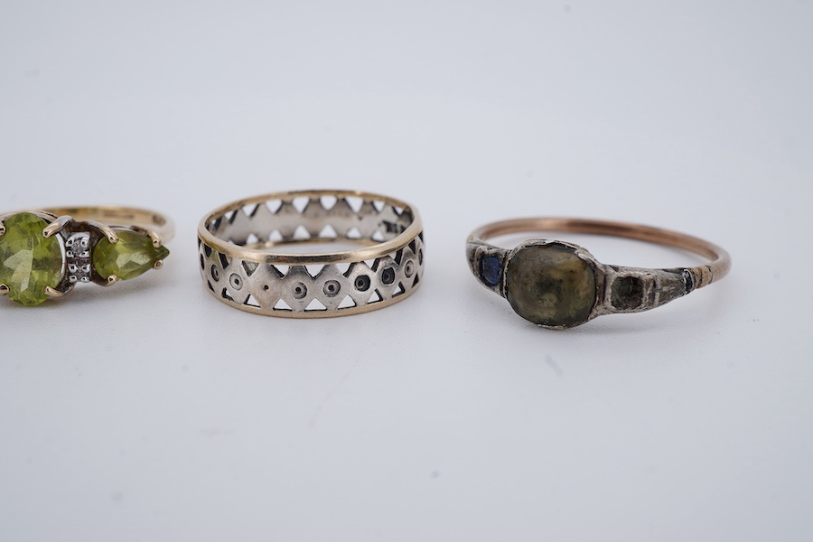 Five rings, comprising: a peridot and diamond ring and a blue topaz ring, each mounted in 9ct gold, sizes J and K1/2; gross weight approximately 3.5 grams; a gold ring set with cushion-shaped diamonds, shank broken, one